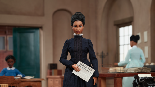 Ida B. Wells Barbie doll holding newspaper in right hand