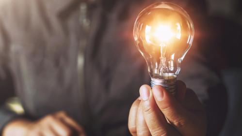 Hand holding light bulb. idea concept with innovation and inspiration
