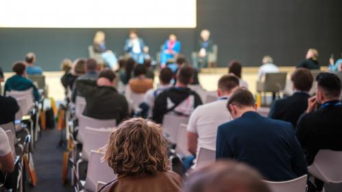 Audience members listening in on a panel discussion