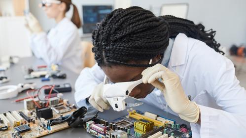 Engineers inspecting computer parts in quality control lab