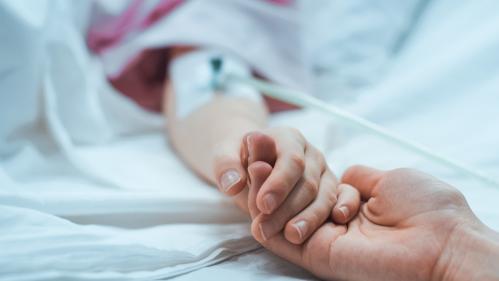 Child hand holding adult hand