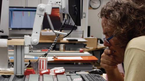 scientist studies sediment samples in ocean vessel laboratory