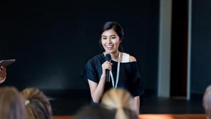 Female speaker with a microphone