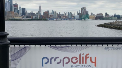 Image of a Propelify sign overlooking the Hudson River and New York City