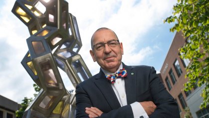Photo of Stephen Burley in front of a large metal collagen structure