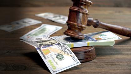 dollars on a table at a court house