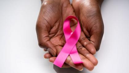 image of hands holding pink ribbon used for breast cancer awareness