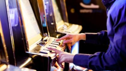 Man using an electronic slot machine