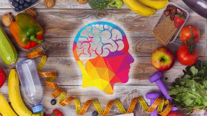 Human head and brain over assortment of healthy fruits and vegetables