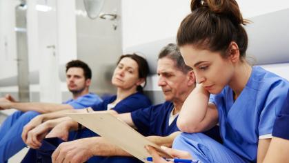 Overworked Nurses sitting on floor