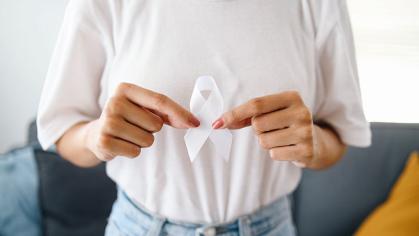 Female wear white casual t-shirt and holding white ribbon for Lung Cancer Awareness