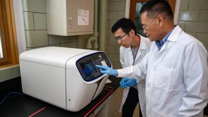 Liping Zhao (foreground) and Gary Guojun Wu work on high resolution data mining at Rutgers Center for Microbiome Analysis