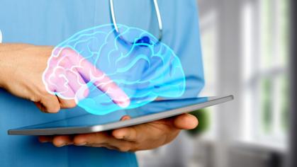 Nurse tapping tablet with transparent image of brain above screen