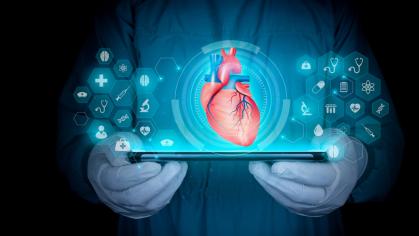 Medical professional holding tablet with transparent image of heart above