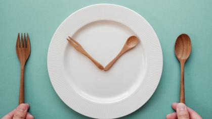 knife and spoon arranged like clock hands on plate