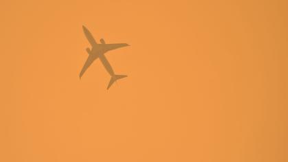 jet seen through wildfire smoke