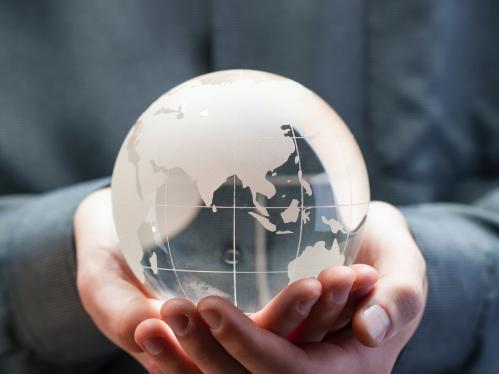 Hands holding glass globe