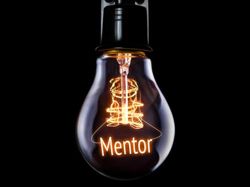 A light bulb hanging with the word Mentor lit up inside