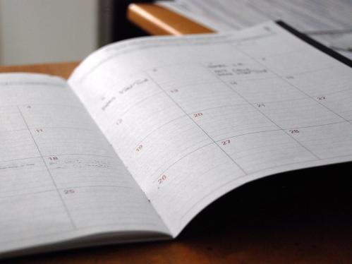 Open day planner on a wooden desk