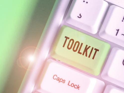 Partial keyboard with light green "TOOLKIT" key instead of Tab key