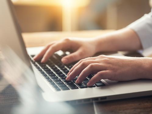 Woman typing on laptop