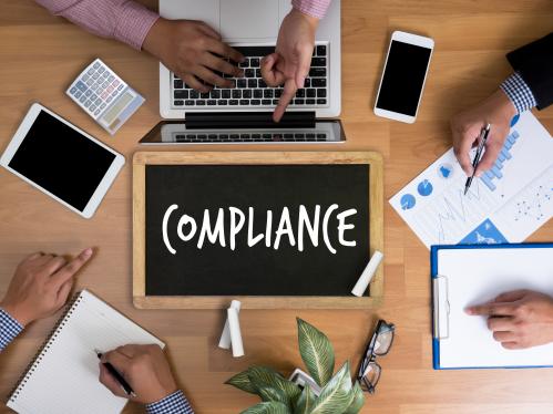 Group of employees discussing compliance issues
