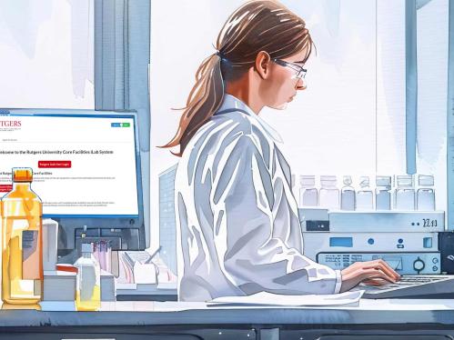 Laboratory scene with woman looking at computer.