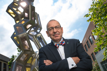 Photo of Stephen Burley in front of a large metal collagen structure