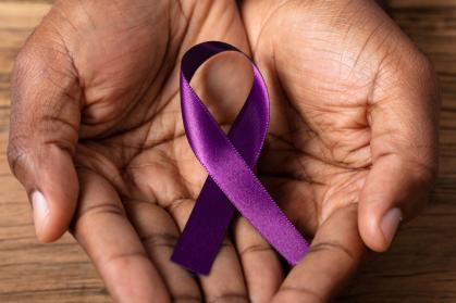 hands holding alzheimer disease ribbon 