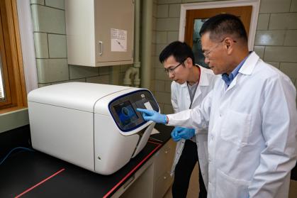 Liping Zhao (foreground) and Gary Guojun Wu work on high resolution data mining at Rutgers Center for Microbiome Analysis