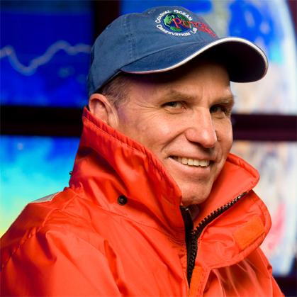Man in blue cap and orange jacket