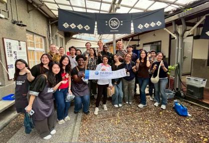 Rutgers graduate Jack Woods (back row, left of center) and members of the New Taipei City cohort pose for a photo while taking part in a traditional clothes-dyeing activity.