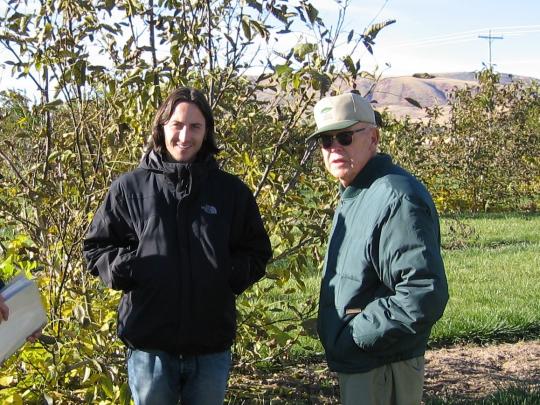 Tom Molnar and Reed Funk in 2007 standing in a hazelnut tree farm